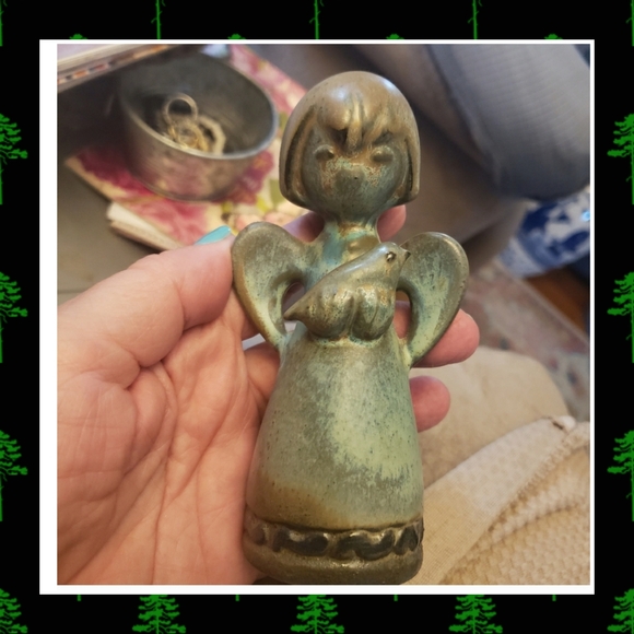 Howard pierce angel holding bird figurine